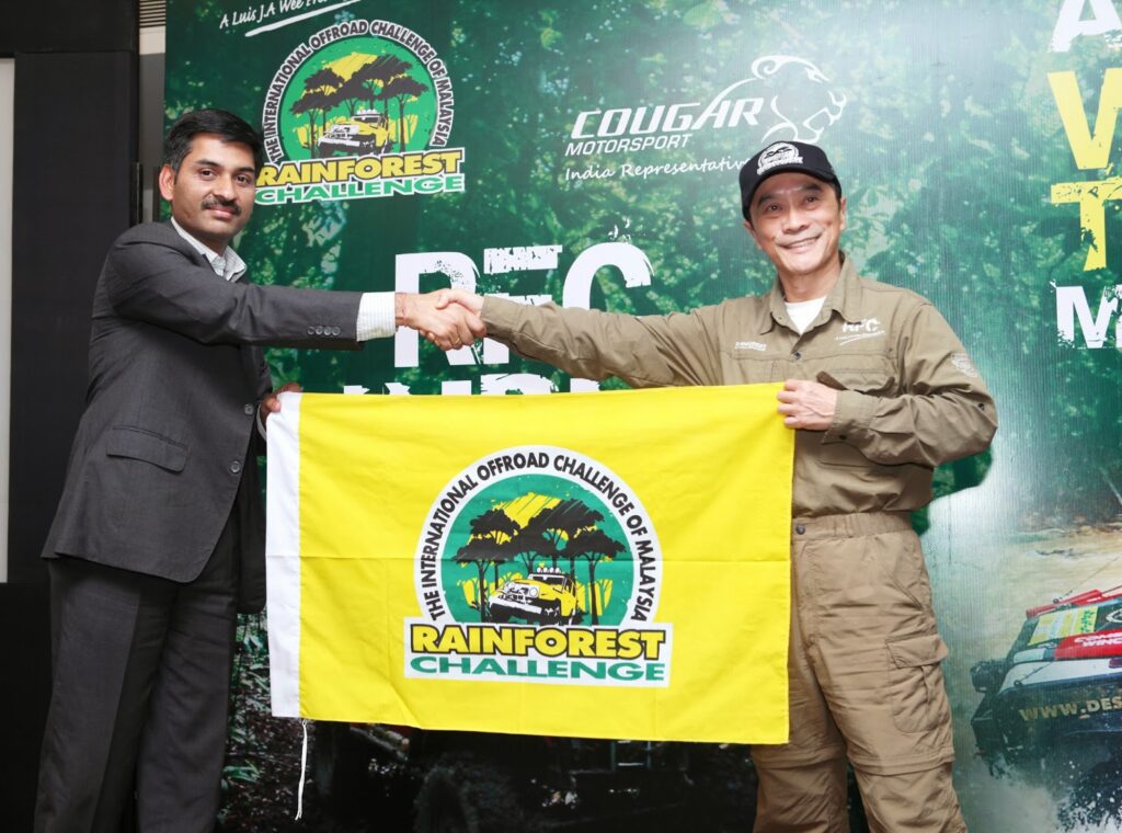 Ashish Gupta (L) receiving the Rainforest Challenge Flag from RFC Founder Luis J.A. Wee