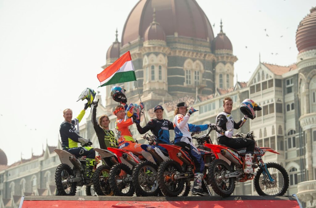 Six world renowned freestyle motorcross athletes with the national flag